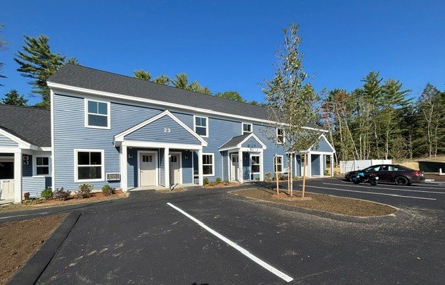 New blue and grey townhouse buildings with fresh paving at Harriman Hill, New Hampshire